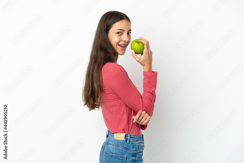 Young French girl isolated on white background eating an apple Young French girl isolated on white background eating an apple