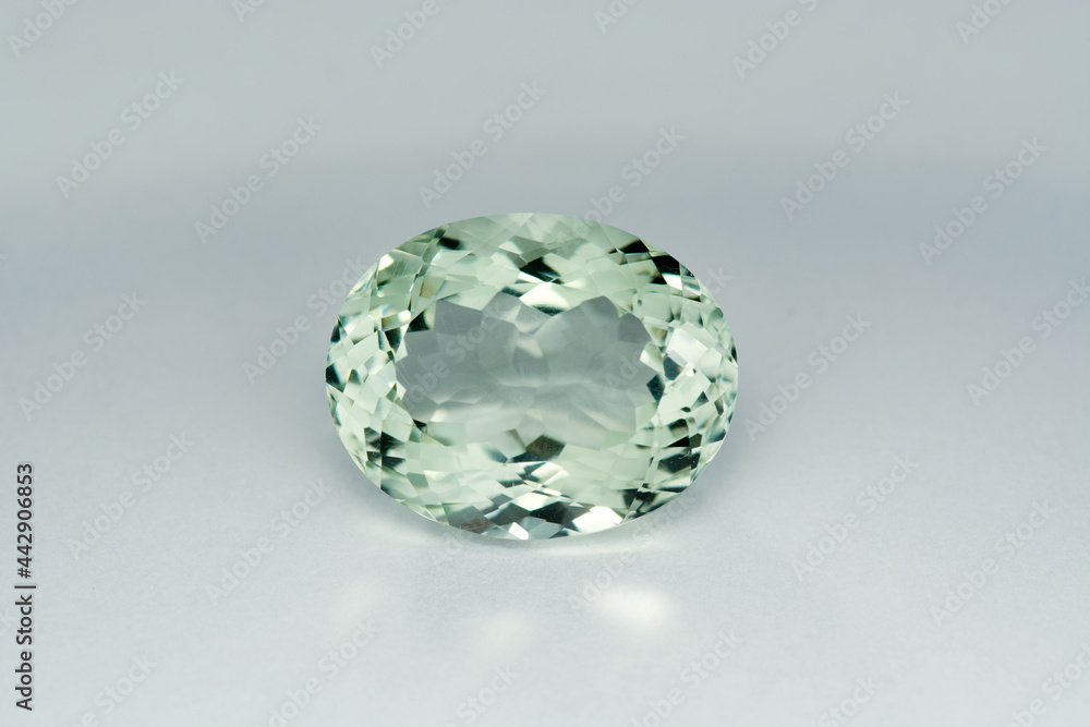 Natural in Brazil mined light green prasiolite amethyst oval faceted, transparent, semiprecious heated, treated gemstone loose setting for designed jewelry making. Gemology theme. Gradient background. Natural in Brazil mined light green prasiolite amethyst oval faceted, transparent, semiprecious heated, treated gemstone loose setting for designed jewelry making. Gemology theme. Gradient background.
