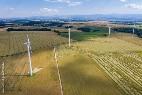 Wind turbines in the country filelds. Turbines farm.Village from drone aerial view. Beautiful village with houses and fields in Nysa, Poland. Polish farmland photo