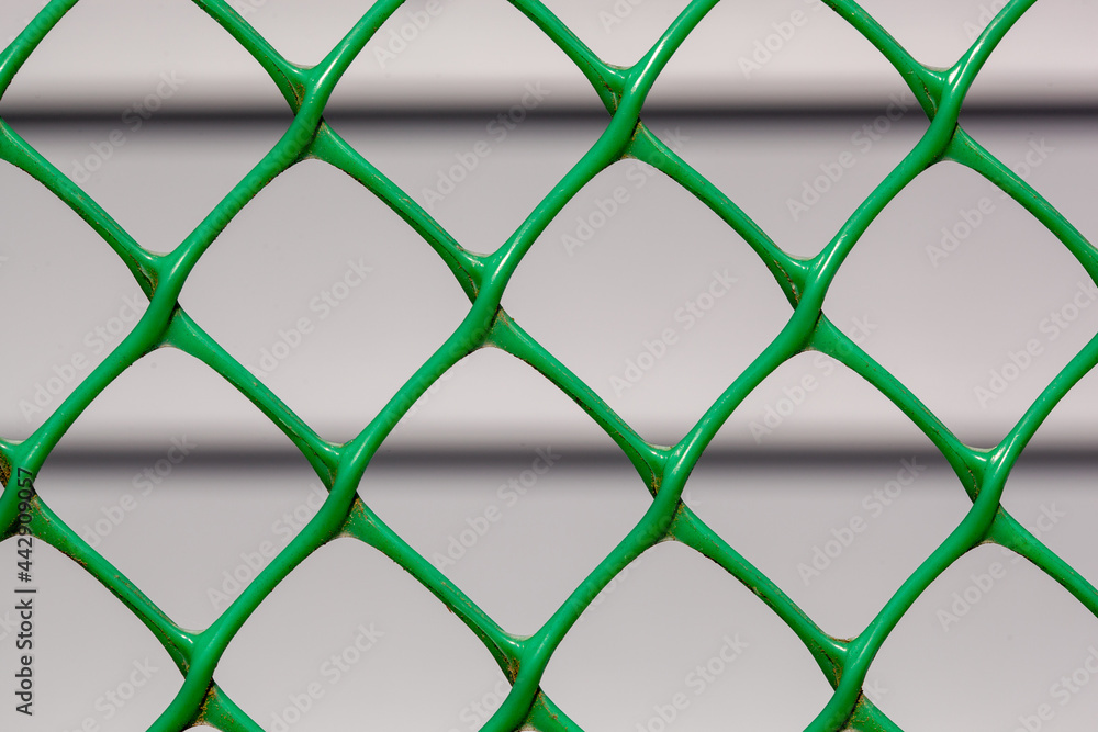 Farmhouse from siding through the chain-link fence that is in focus Farmhouse from siding through the chain-link fence that is in focus