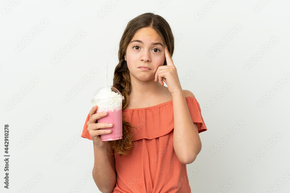 Little caucasian girl with strawberry milkshake isolated on white background thinking an idea Little caucasian girl with strawberry milkshake isolated on white background thinking an idea