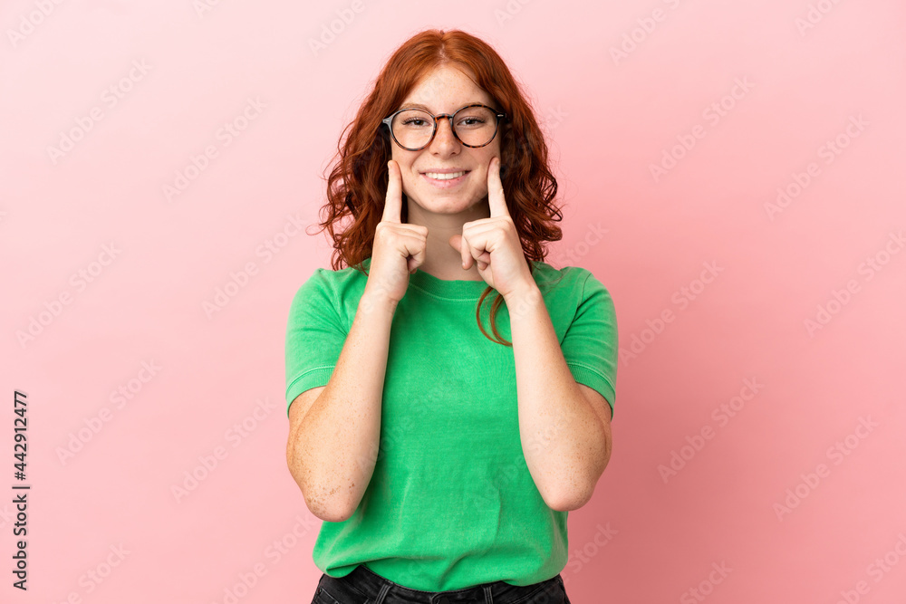 Teenager redhead girl over isolated pink background smiling with a happy and pleasant expression Teenager redhead girl over isolated pink background smiling with a happy and pleasant expression