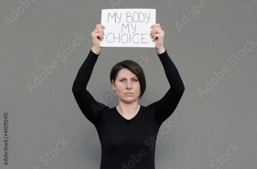 Middle age evropian woman holding a sign with the message My Body My Choice. Feminist protest. Human rights. Legal abortion law.