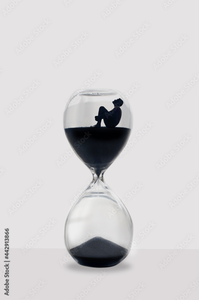Illustration: Man sitting inside an hourglass wait for time to pass. Ideal concept for depression, loneliness, mental health problems, sadness and anxiety patients. Illustration: Man sitting inside an hourglass wait for time to pass. Ideal concept for depression, loneliness, mental health problems, sadness and anxiety patients.