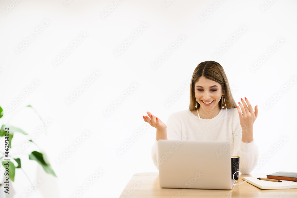 Smiling mixed race lady freelancer, communicating with client via video computer call. Millennial pleasant professional female tutor giving online language class.