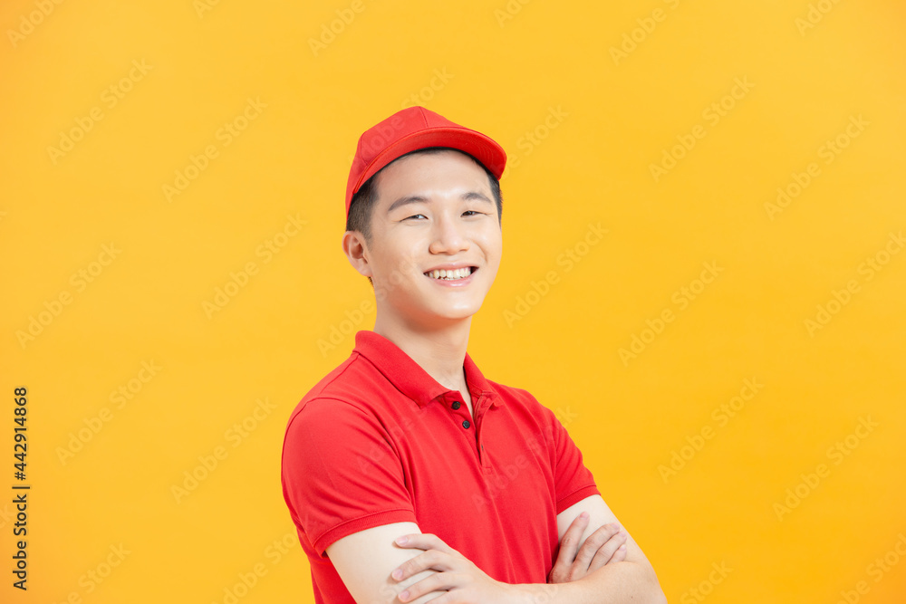 Confident Asian delivery man smiles and looks at camera with crossed arms. Confident Asian delivery man smiles and looks at camera with crossed arms.