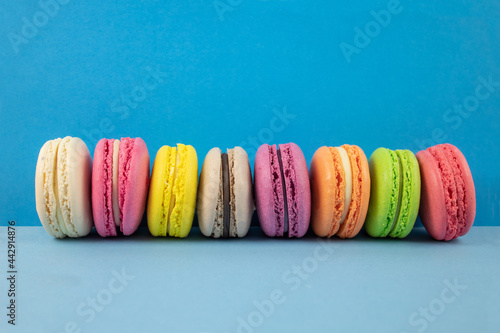 Multicolored macaroons on a blue background
