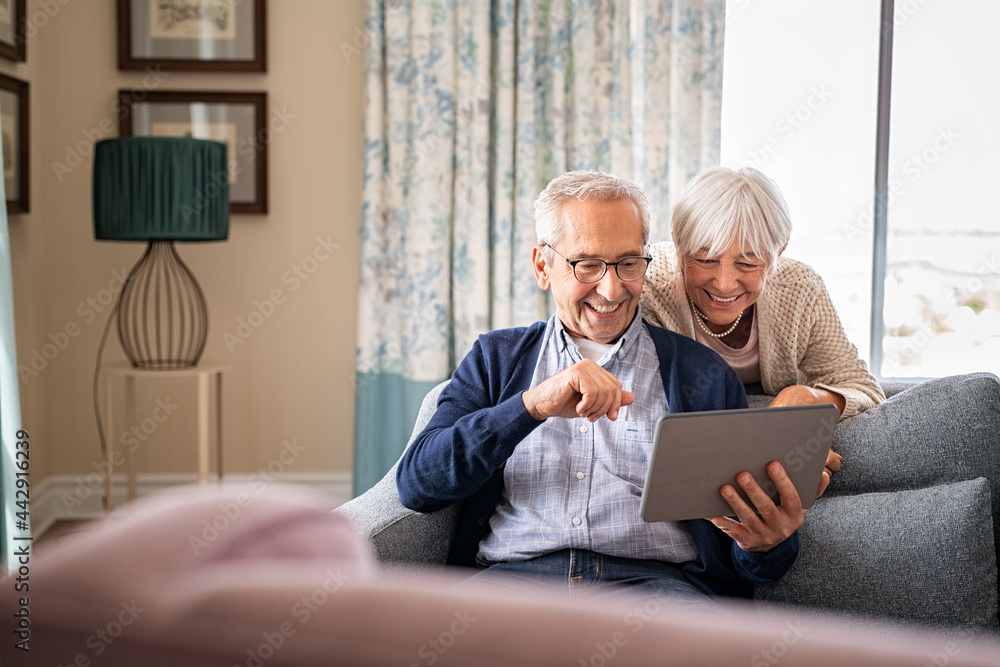 Senior couple using digital tablet for a video call with family Senior couple using digital tablet for a video call with family