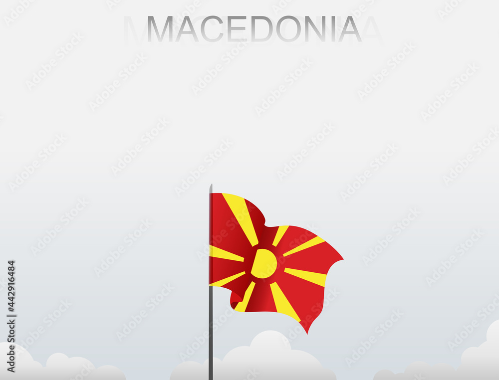 Macedonian flag flutters on a pole standing tall under a white sky Macedonian flag flutters on a pole standing tall under a white sky