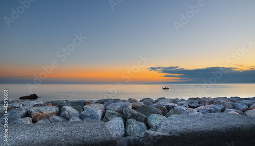wonderful sunset over the sea in Camogli, colorful rocks frame this glimpse of paradise