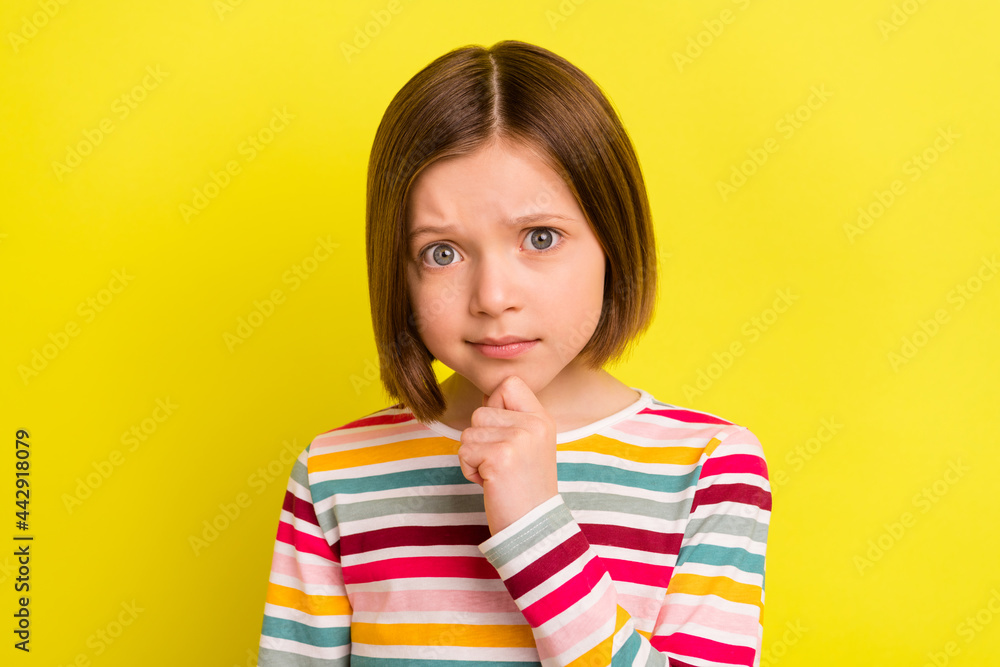 Photo of minded young serious little girl hold hand chin ponder think face isolated on yellow color background Photo of minded young serious little girl hold hand chin ponder think face isolated on yellow color background