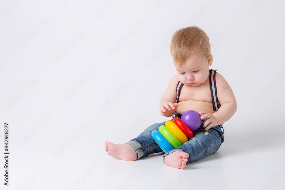 Obraz premium toddler baby boy with toy on white background
