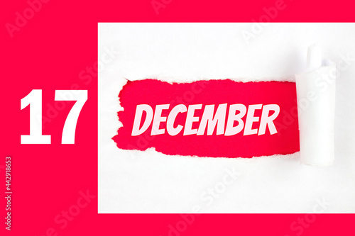 December 17th. Day 17 of month, Calendar date. Red Hole in the white paper with torn sides with calendar date. Winter month, day of the year concept. photo