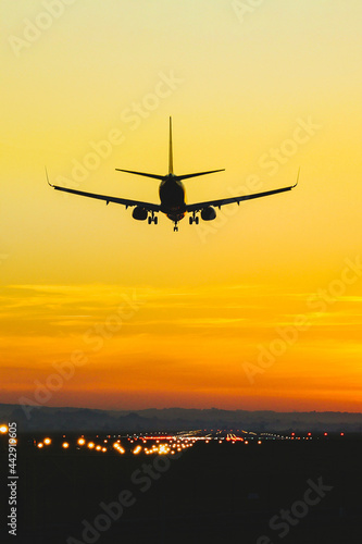 Airplane landing on the runway during sunset and dusk © Bogdan