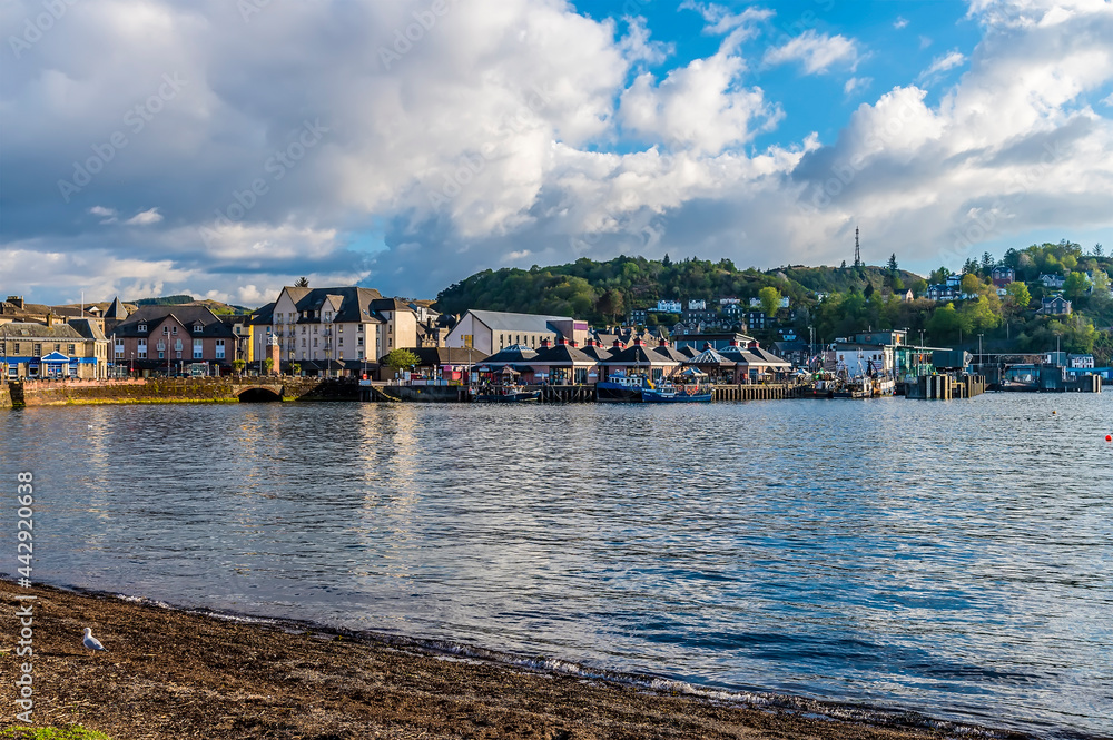 A view from the seafront towards the port in the town of Oban, Scotland on a summers evening