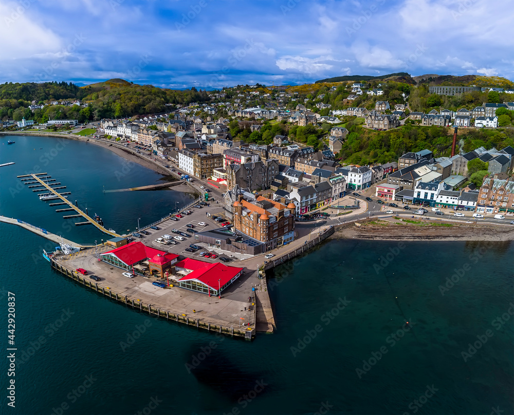 An aerial view above a landing stage and the town of Oban, Scotland on a summers day