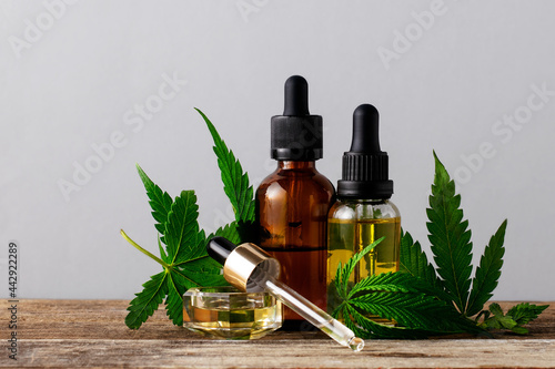 Cannabis oil in bottles on gray background with copy space. photo