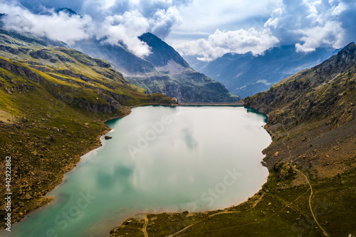 Fototapeta Naklejka Na Ścianę i Meble -  Aerial view of dam in inspiring alpine mountains