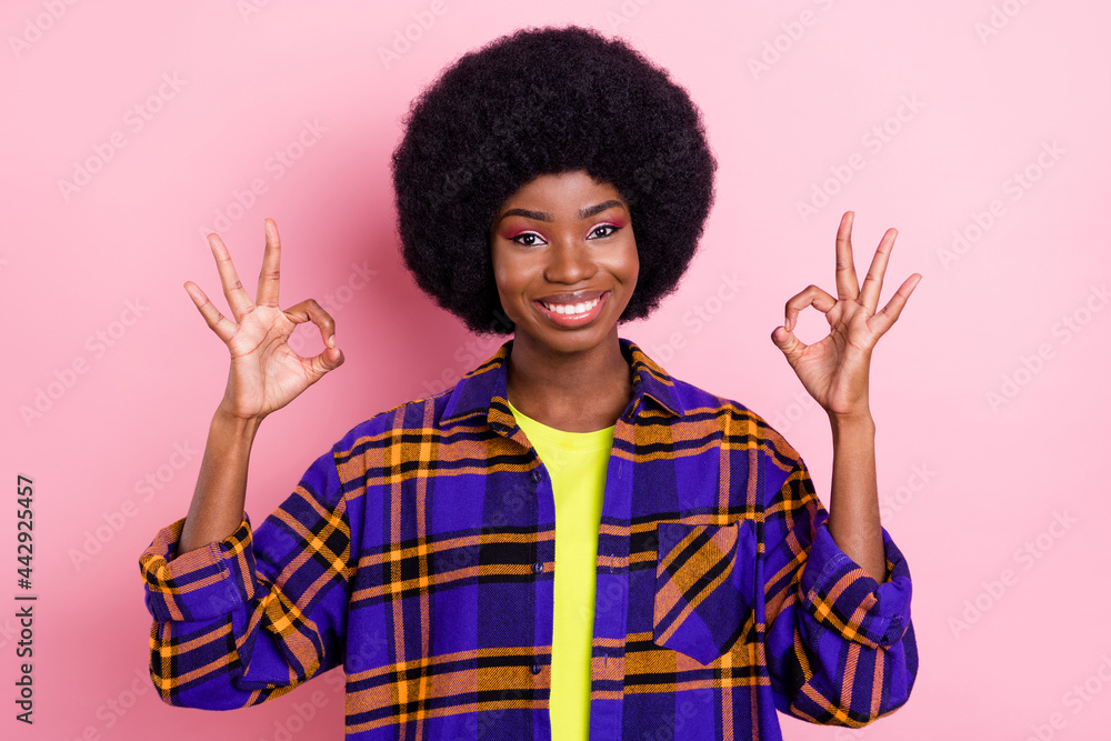 Portrait of attractive cheerful girl showing double ok-sign ad solution isolated over pink pastel color background Portrait of attractive cheerful girl showing double ok-sign ad solution isolated over pink pastel color background