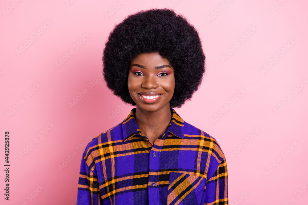 Portrait of attractive cheerful content girl wearing checked shirt isolated over pink pastel color background Portrait of attractive cheerful content girl wearing checked shirt isolated over pink pastel color background