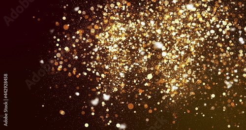 Sparkling golden particles floating upwards on a dark background