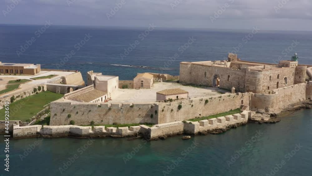 Beautiful drone view of Maniace Castle in Siracusa Ortigia Island in a beautiful summer day surrounded by crystal blue water of mediterranean sea in Sicily, Italy.
Beautiful drone view of Maniace Castle in Siracusa Ortigia Island in a beautiful summer day surrounded by crystal blue water of mediterranean sea in Sicily, Italy.
