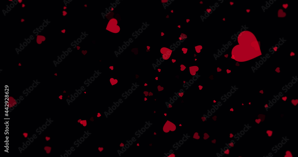 Red hearts floating around on a black background Red hearts floating around on a black background