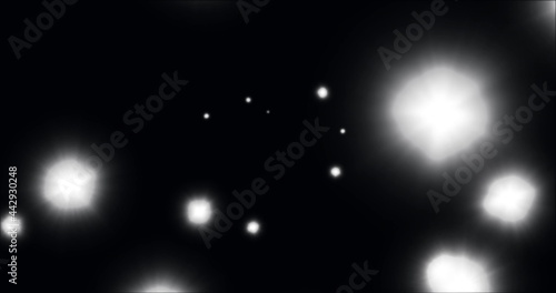 Image of glowing white spots of light moving in hypnotic motion on black background