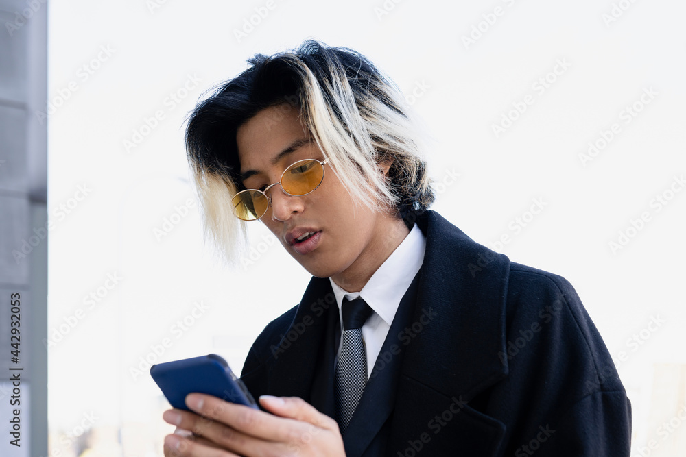 Asian businessman in formal wear with smartphone Asian businessman in formal wear with smartphone