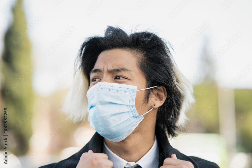 Asian businessman in sterile mask in town Asian businessman in sterile mask in town