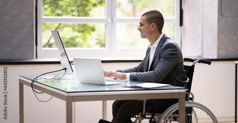 Handicapped Businessman Using Laptop Computer Handicapped Businessman Using Laptop Computer