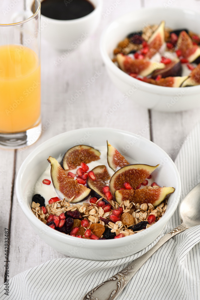 Healthy and delicious breakfast. Oatmeal muesli with Greek yogurt, fresh figs, dried fruits and pomegranate. Healthy and delicious breakfast. Oatmeal muesli with Greek yogurt, fresh figs, dried fruits and pomegranate.