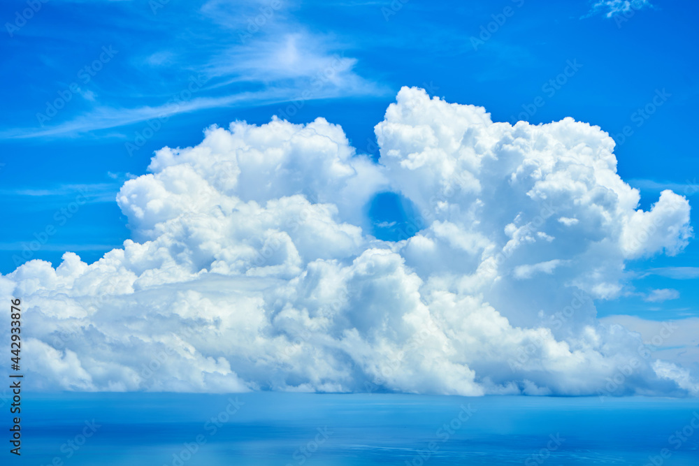 Fluffy white clouds over blue ocean water