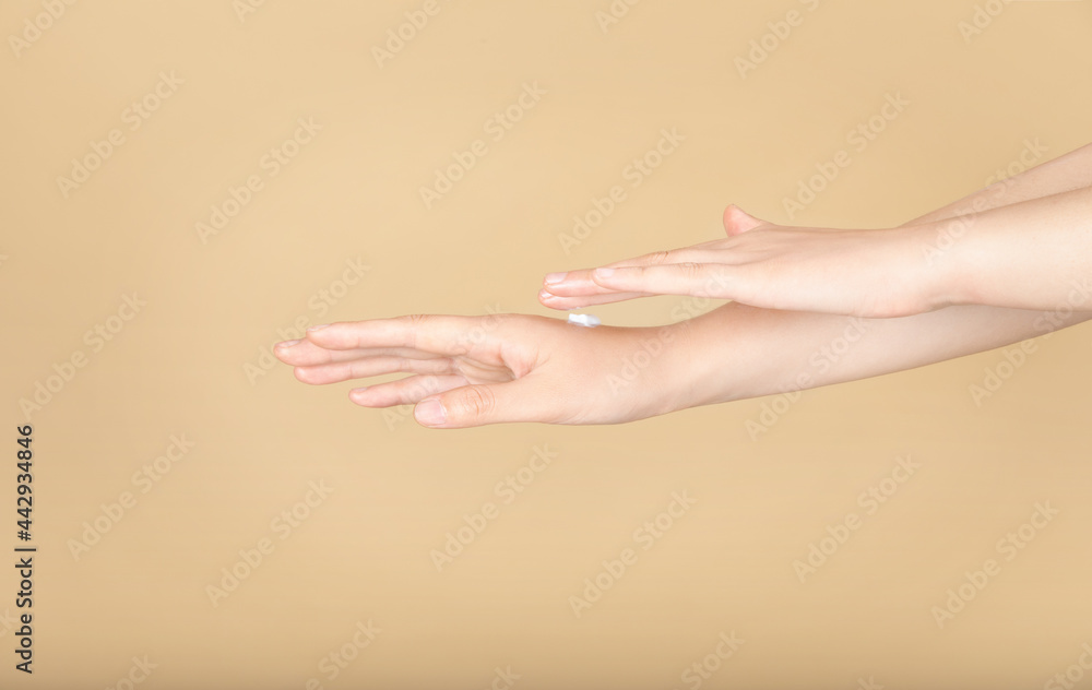 scene of woman applying lotion on her hands scene of woman applying lotion on her hands