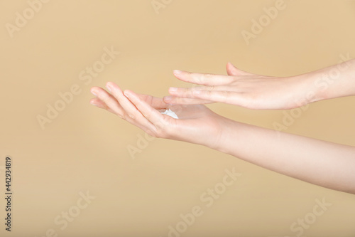 scene of woman applying lotion on her hands