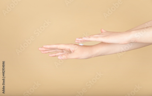 scene of woman applying lotion on her hands