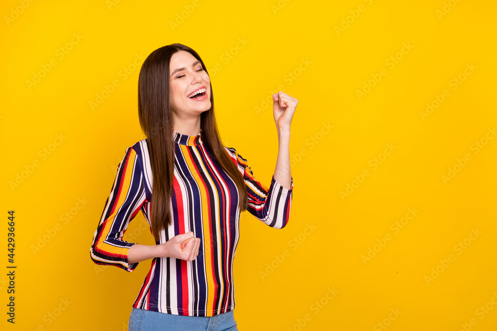 Profile side photo of young attractive woman happy positive smile rejoice victory success isolated over yellow color background Profile side photo of young attractive woman happy positive smile rejoice victory success isolated over yellow color background