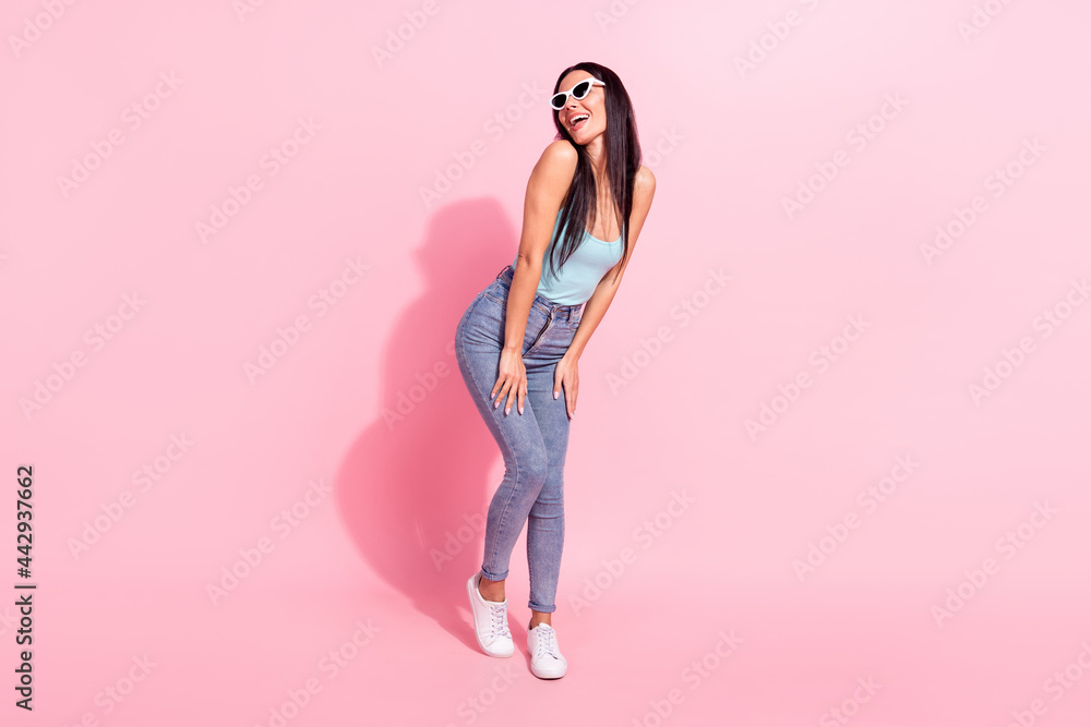 Full length body size photo woman in sunglass laughing overjoyed in summer isolated pastel pink color background Full length body size photo woman in sunglass laughing overjoyed in summer isolated pastel pink color background