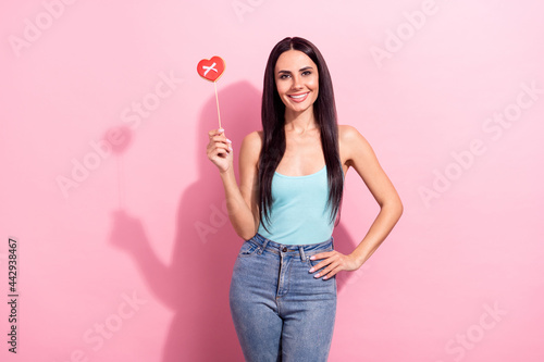 Photo portrait pretty brunette keeping sweet heart shaped cookie isolated pastel pink color background