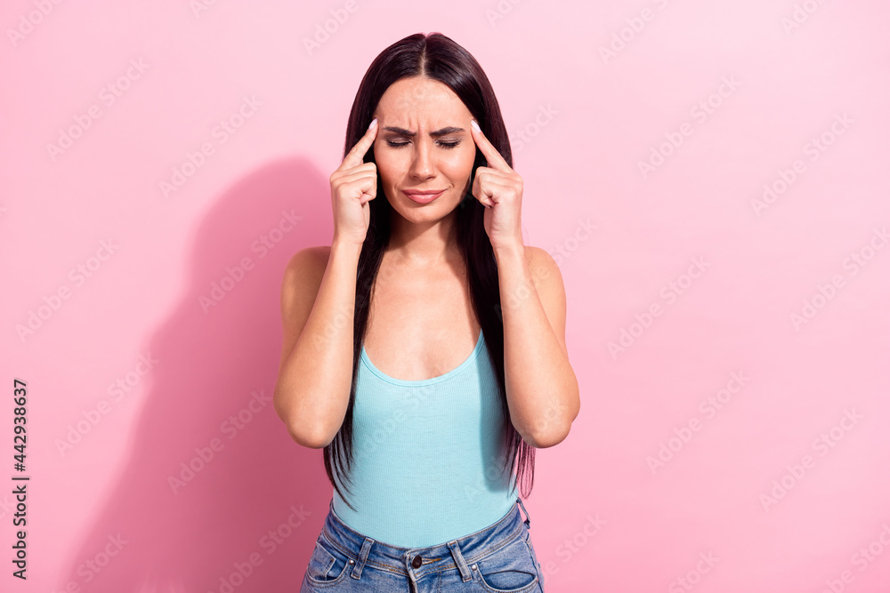 Photo portrait of young woman suffering from headache need medicine isolated on pastel pink color background Photo portrait of young woman suffering from headache need medicine isolated on pastel pink color background