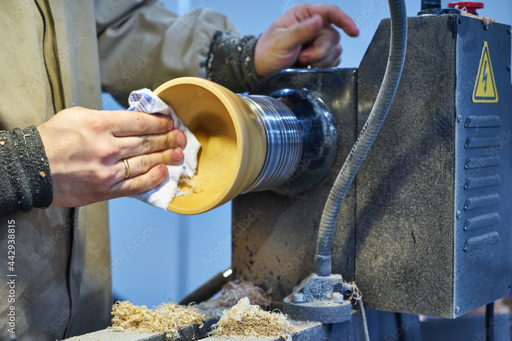 Making a wooden vase on a lathe.