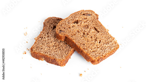 Black, rye bread with dried fruit on a white background.