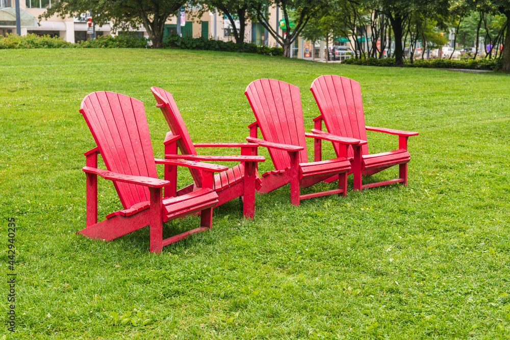 Colorful armchairs (muskoka chairs) on the green lawn of a public park in Toronto. Colorful armchairs (muskoka chairs) on the green lawn of a public park in Toronto.
