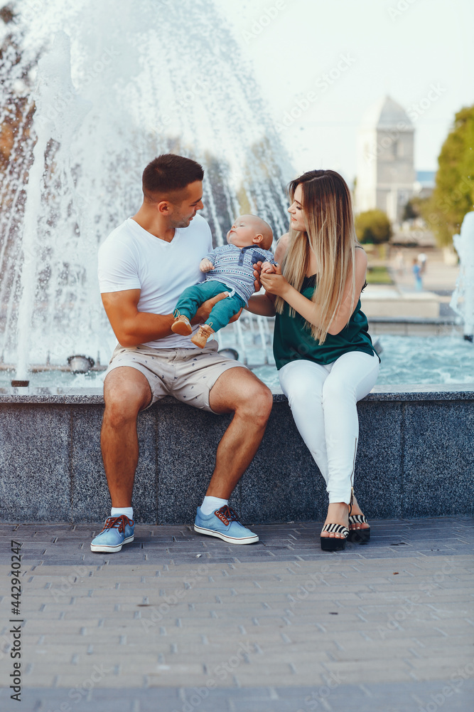 Cute family playing in a summer city Cute family playing in a summer city