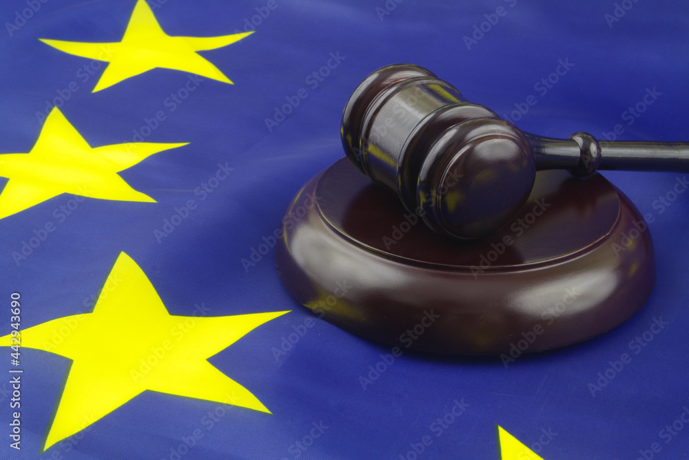 Wooden judge gavel on European Union flag. Laws and court in EU concept.	