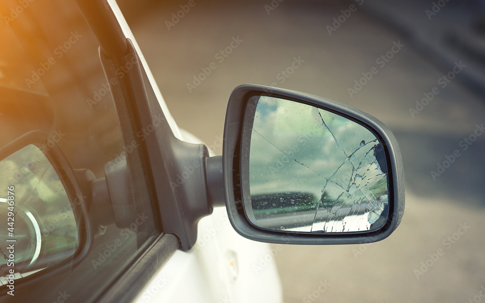 Broken side door wing mirror. Damaged car side mirror, cracked glass. Bad driving, problems with car. Road accident concept