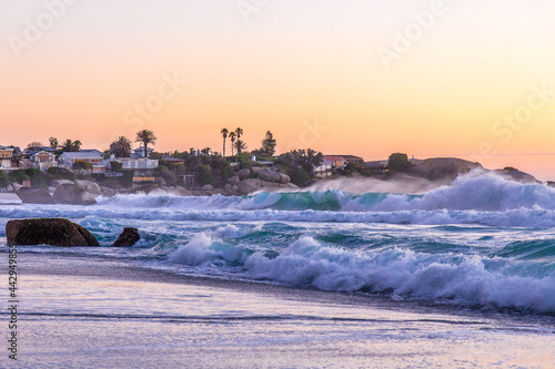 Atardecer en Clifton Beach, en Ciudad del Cabo (Sud África), las grandes olas al atardecer llegan a la costa. photo
