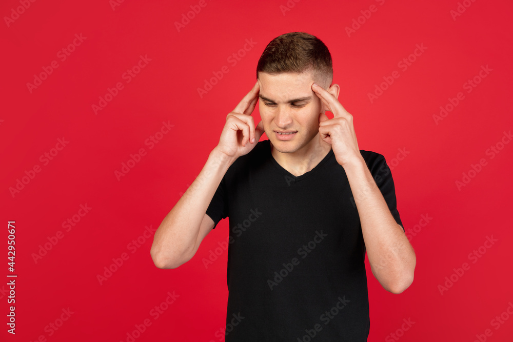 Caucasian man's portrait isolated over red studio background with copyspace for ad. Concept of human emotions Caucasian man's portrait isolated over red studio background with copyspace for ad. Concept of human emotions