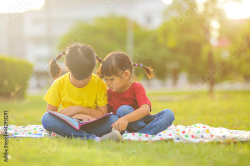 Wallpaper Mural Smiling little asian girl happy small sitting on nature in the park. Which increases the development and enhances outside the classroom  learning skills concept. Torontodigital.ca