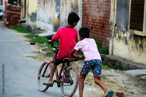 Photography young boys playing learning while riding a bicycle street photography roadside